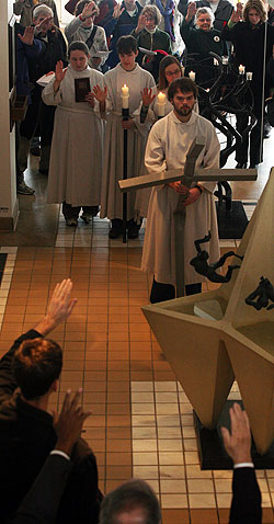 The Christ Chapel steeple cross, which was bent in the 1998 tornado, is blessed before being hung from the ceiling in Christ Chapel on March 17, 2008.  The service marked the 10-year tornado anniversary.