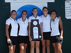 Women's golf team with second place NCAA trophy.